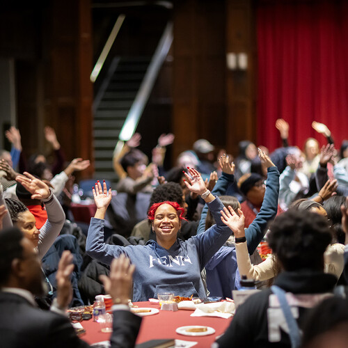 Volunteers dance during a kickoff breakfast on MLK Day