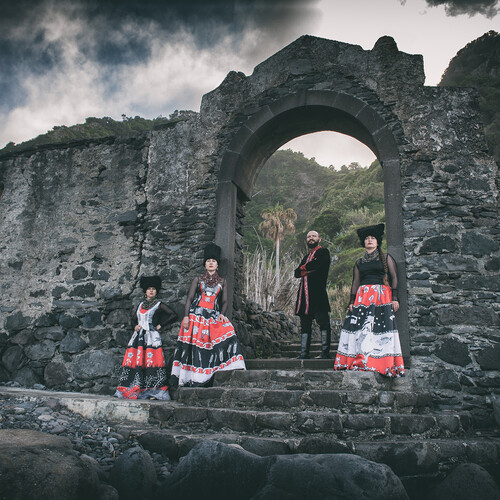 Dakhabraka posing by stone archway.