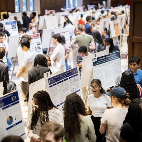Students in Houston Hall looking at posters during Penn’s CURF Poster Expo.
