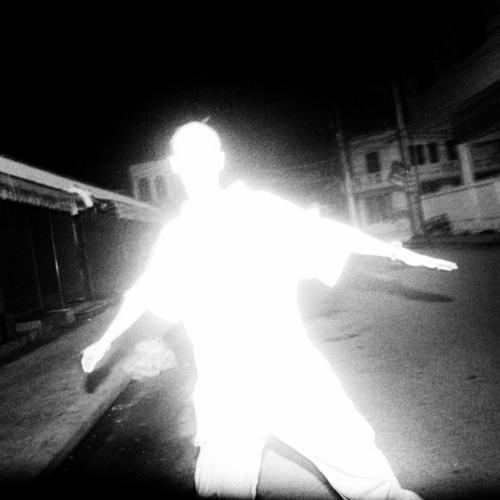 Vibrant silhouette with a dark, cityscape background.
