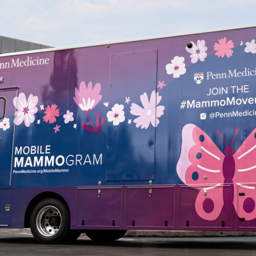 Penn Medicine's mobile mammogram van. The vehicle is a blend of pink, blue, and violet, with a pink butterfly design.