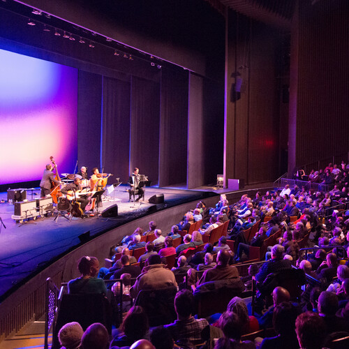 A full audience viewing a performance at Penn Live Arts.