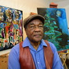 Driskell surrounded by paintings