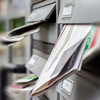 Grey mail slots are full of letters and other post