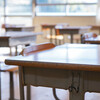 Empty desks in elementary school classroom.