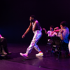 Jerron Herman dances in white and metallic outfit.