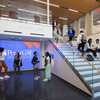 People standing in the lobby of Penn GSE and on the stairs.