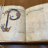An open ancient book of Aristotle in Latin.