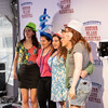 students pose for photo with Senior Class Carnival backdrop