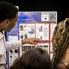 A student talks with an attendee about their poster during Penn’s CURF Poster Expo in Houston Hall.