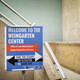 A sign in front of a stairwell reading, "Welcome to the Weingarten Center, Office of Learning Resources, Student Disabilities Services. Take the stairs or elevator to suite 300