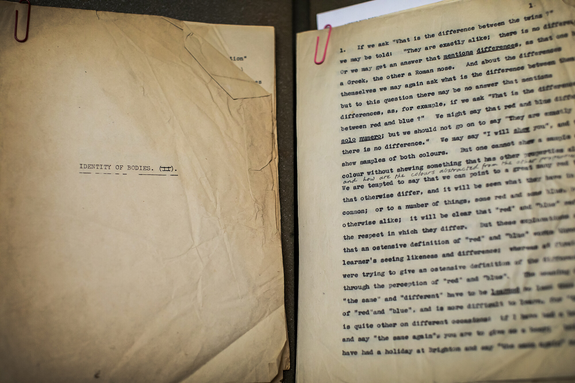 Weathered document produced on a typewriter. The page on the left reads "Identity of bodies." The page on the right is a full page of text.