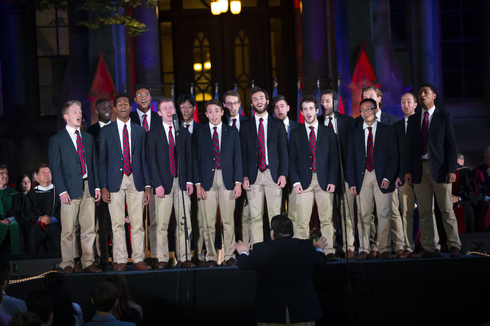 student group singing on stage in front of college hall at convocation 2019
