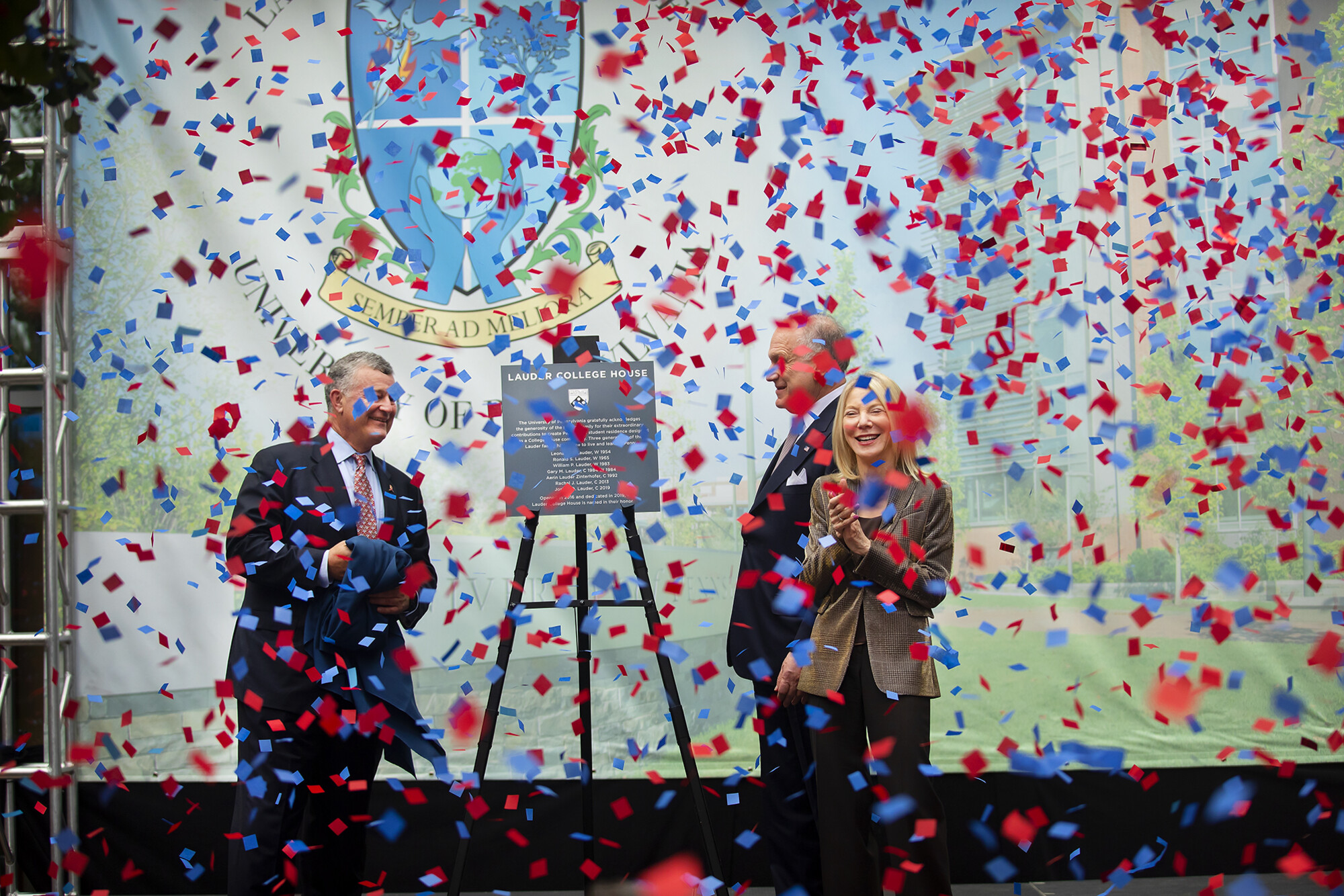 William and Ronald Lauder on stage with Amy Gutmann as confetti falls