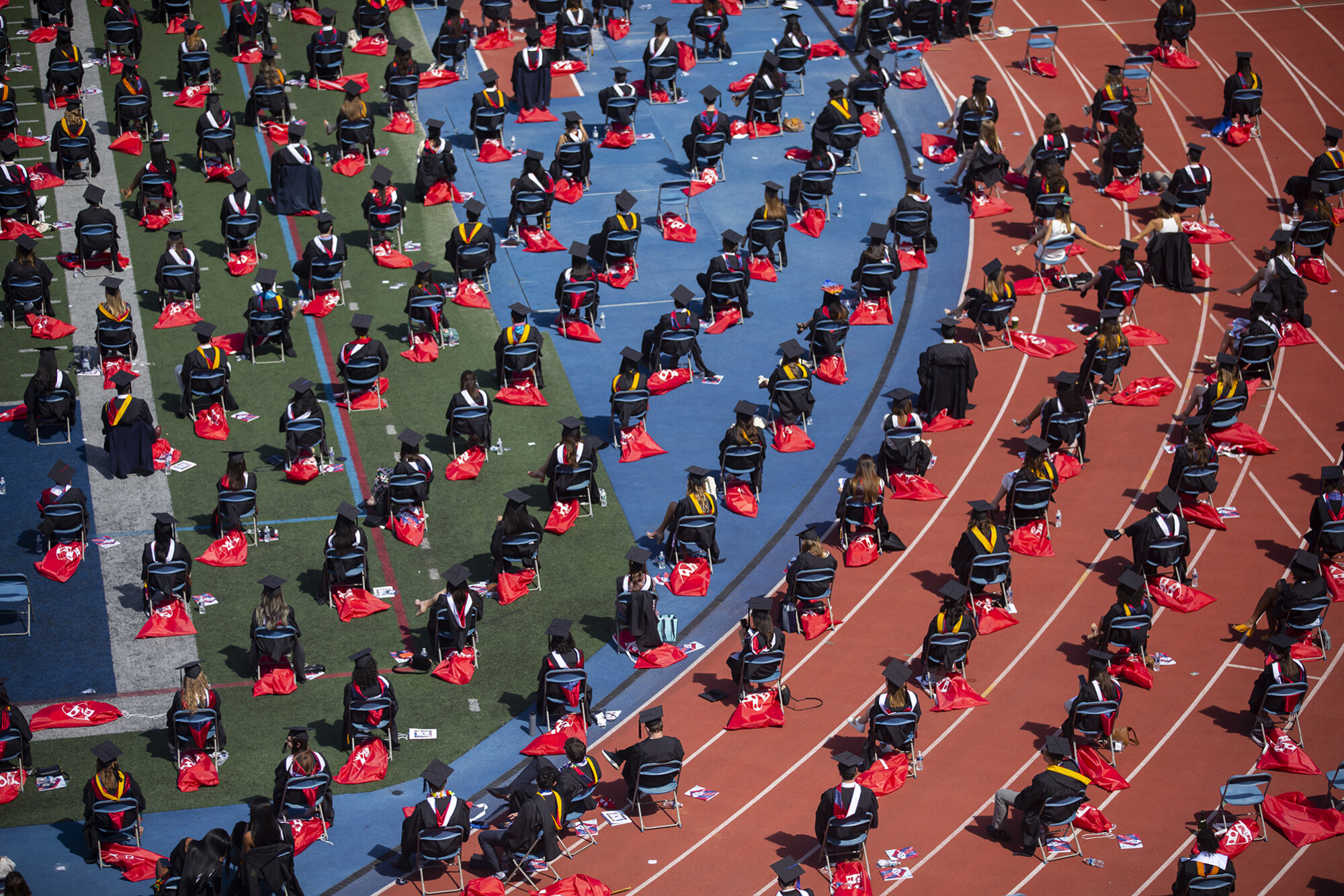 rows of graduates sitting in franklin field