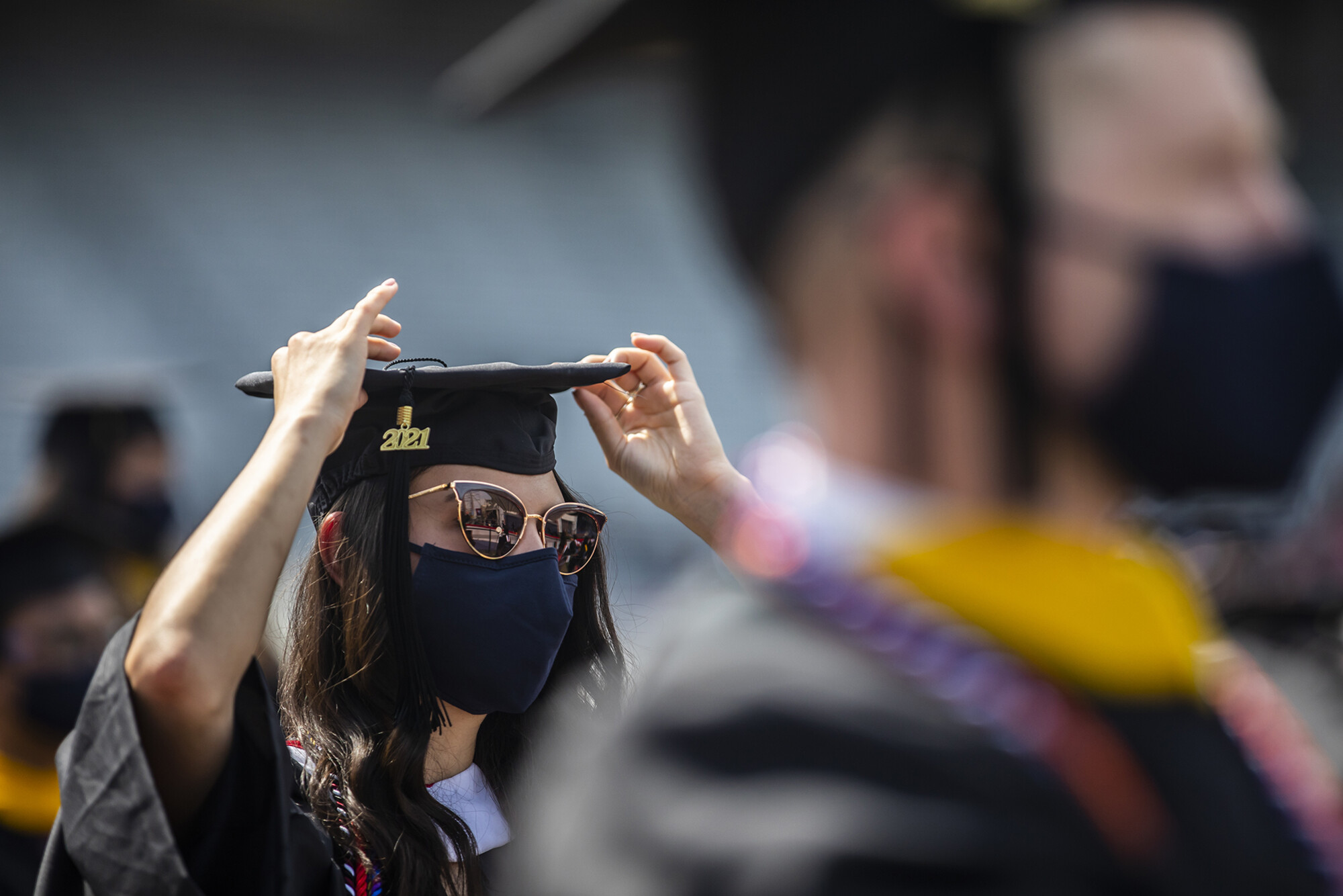 close up of graduate adjusting hat