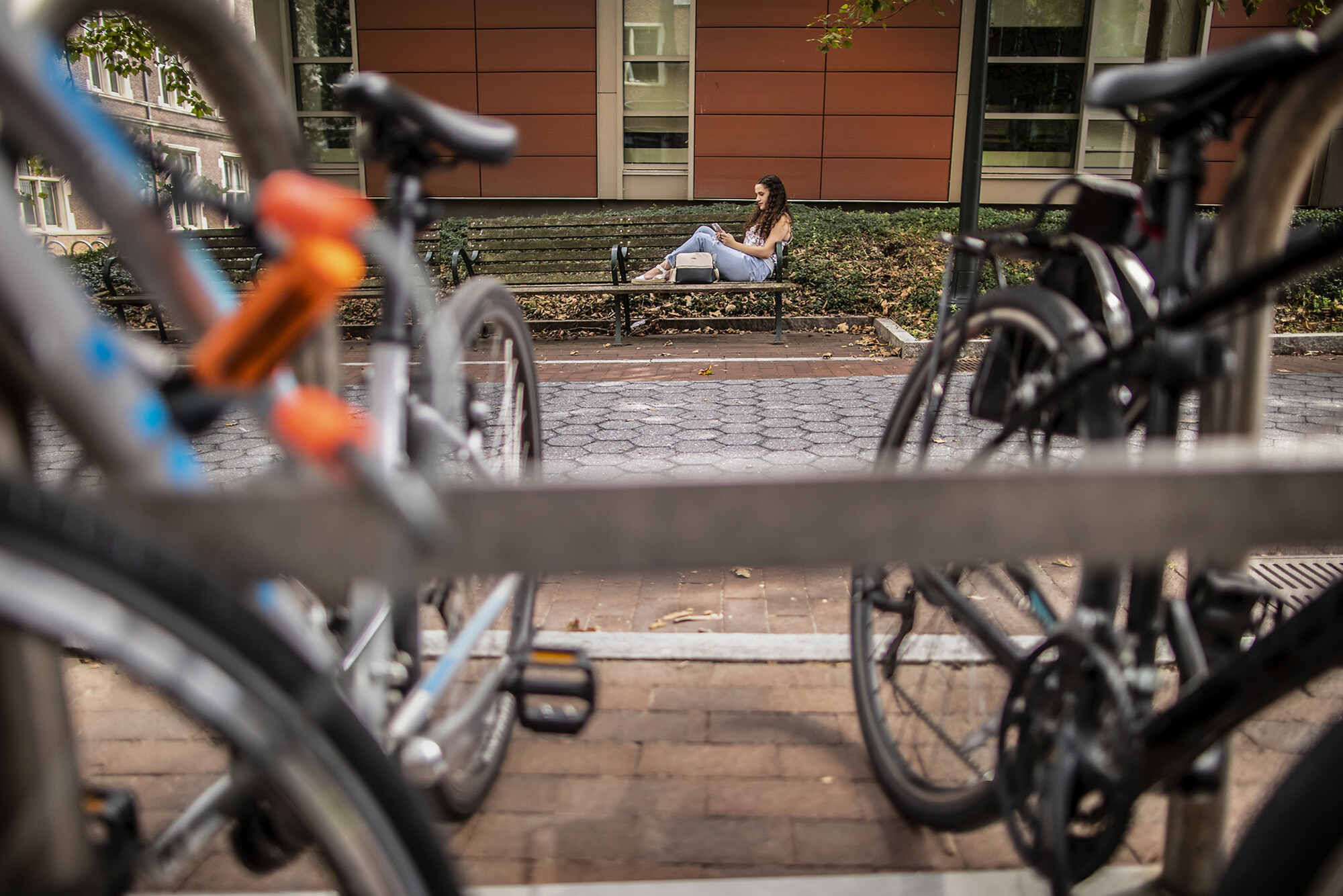 ariana jimenez sitting on a bench with bikes