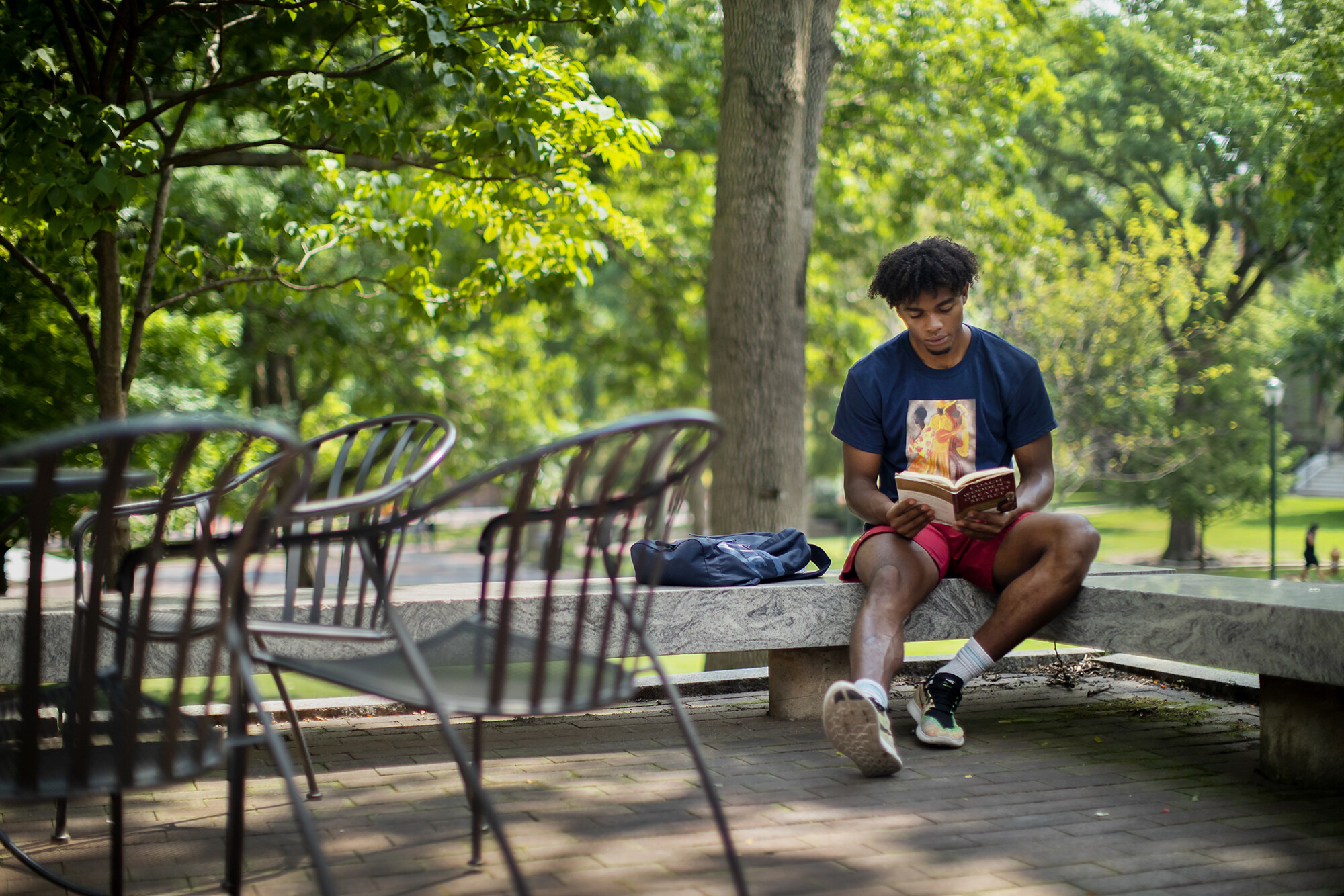 lucas monroe sitting on a bench reading
