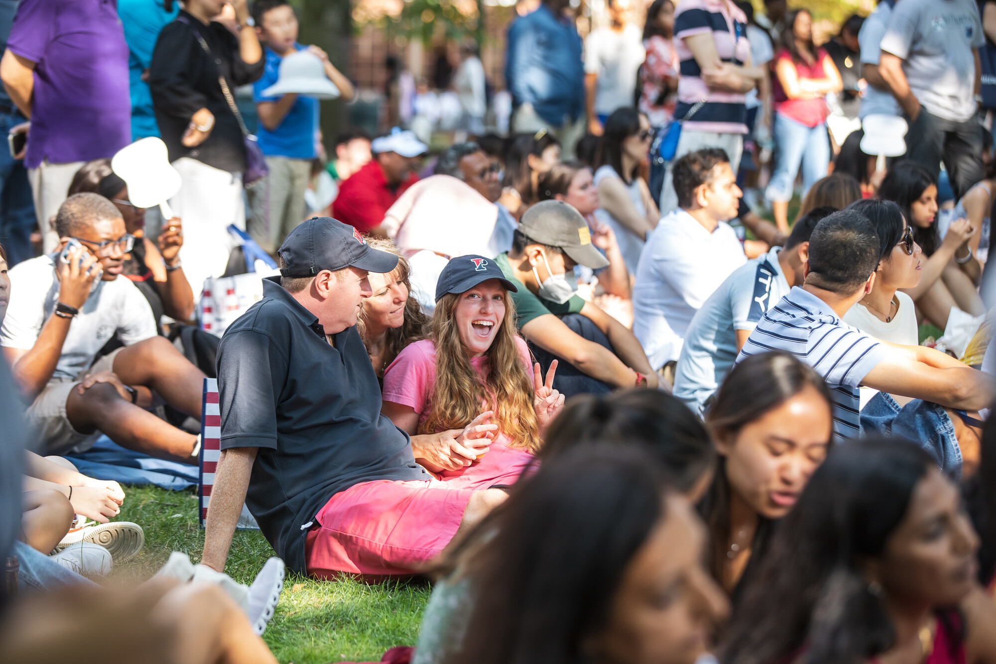 incoming students sit on college green during welcome