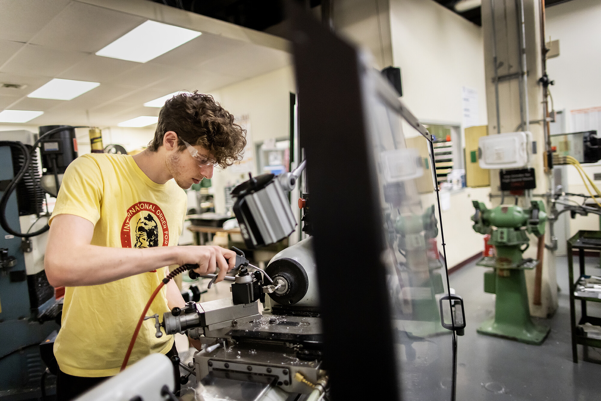 student in meam lab working on machines