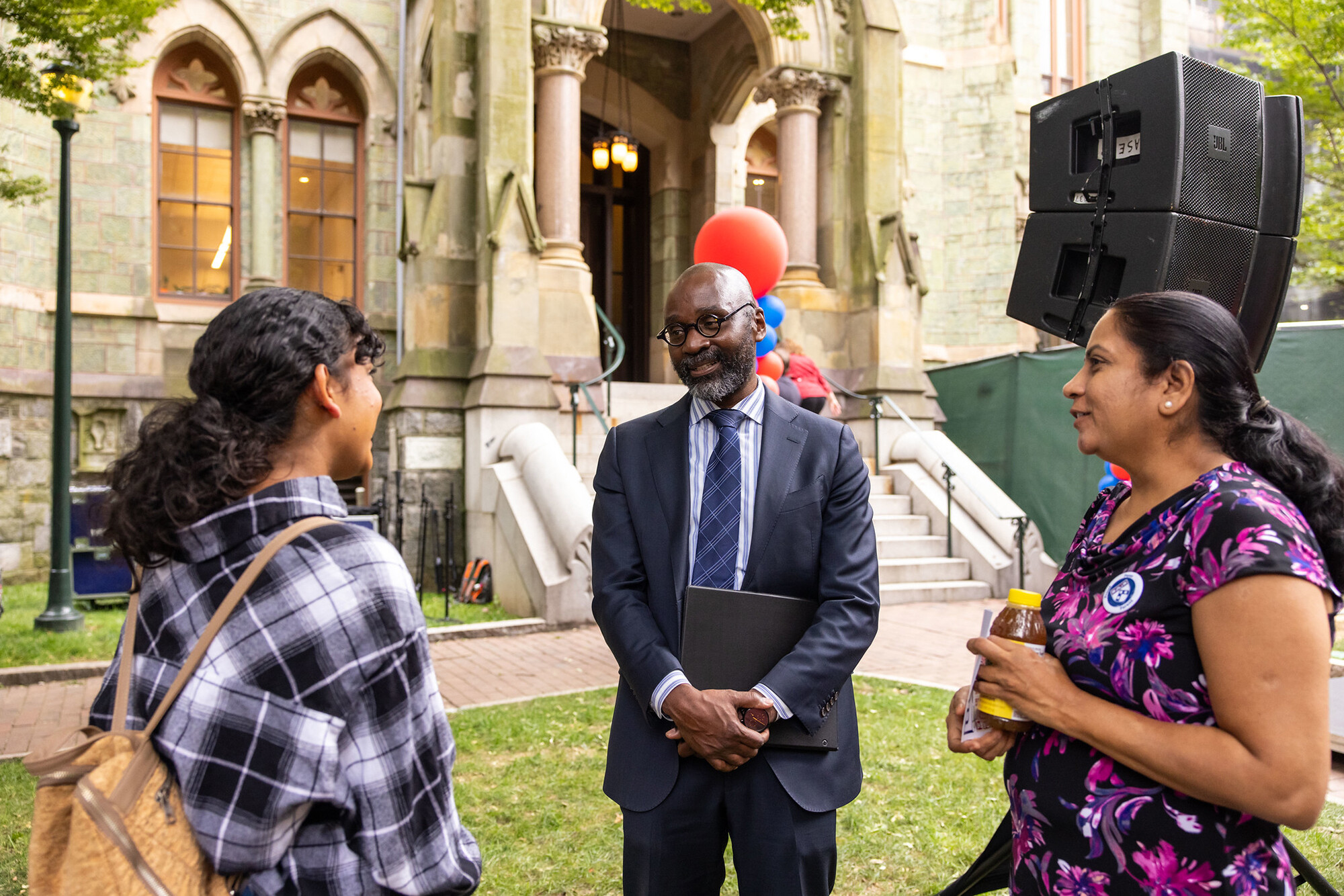 Provost John L. Jackson Jr. in front of College Hall talking to a new student and their family.