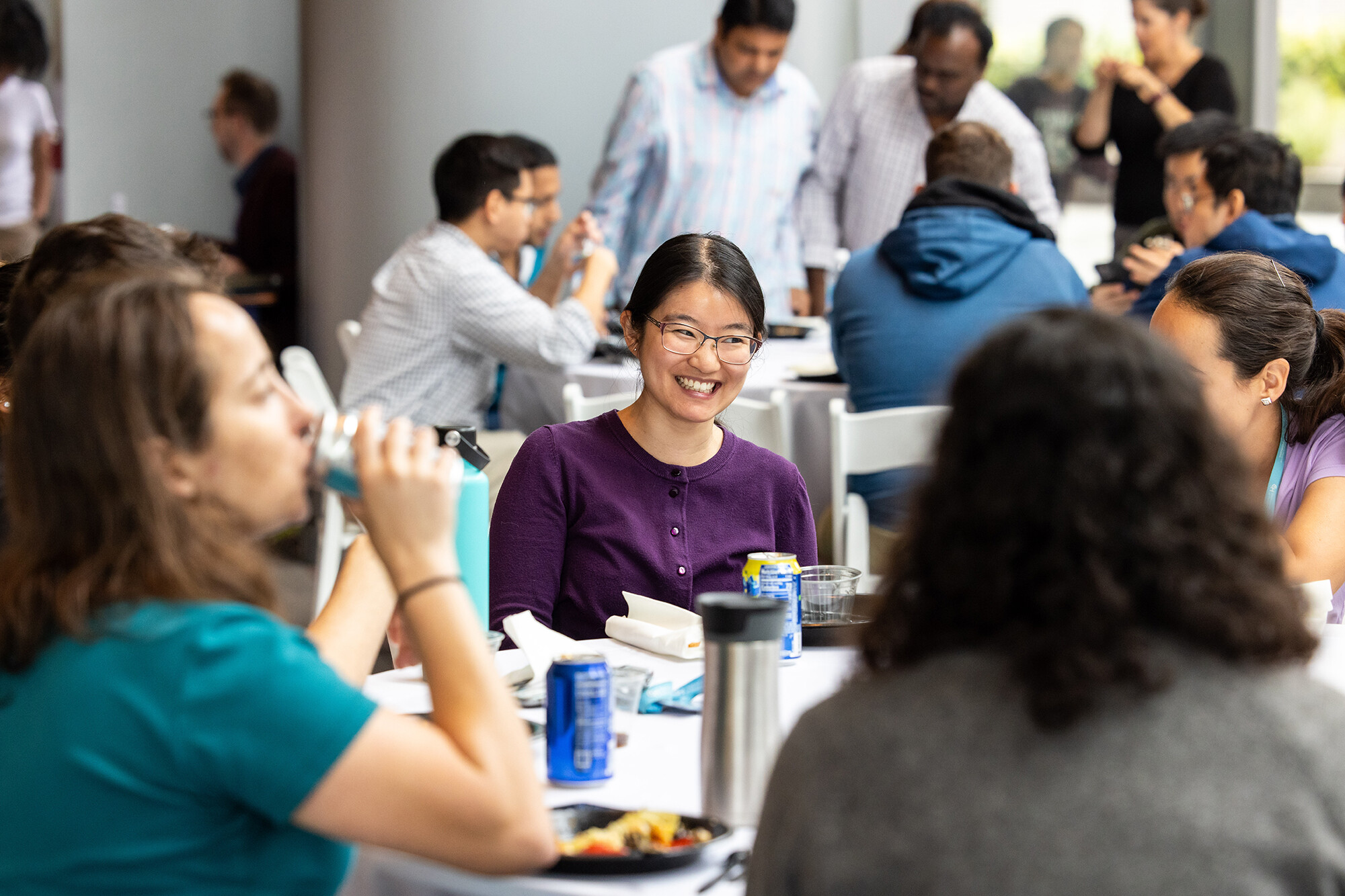 postdoc smiles at table with others