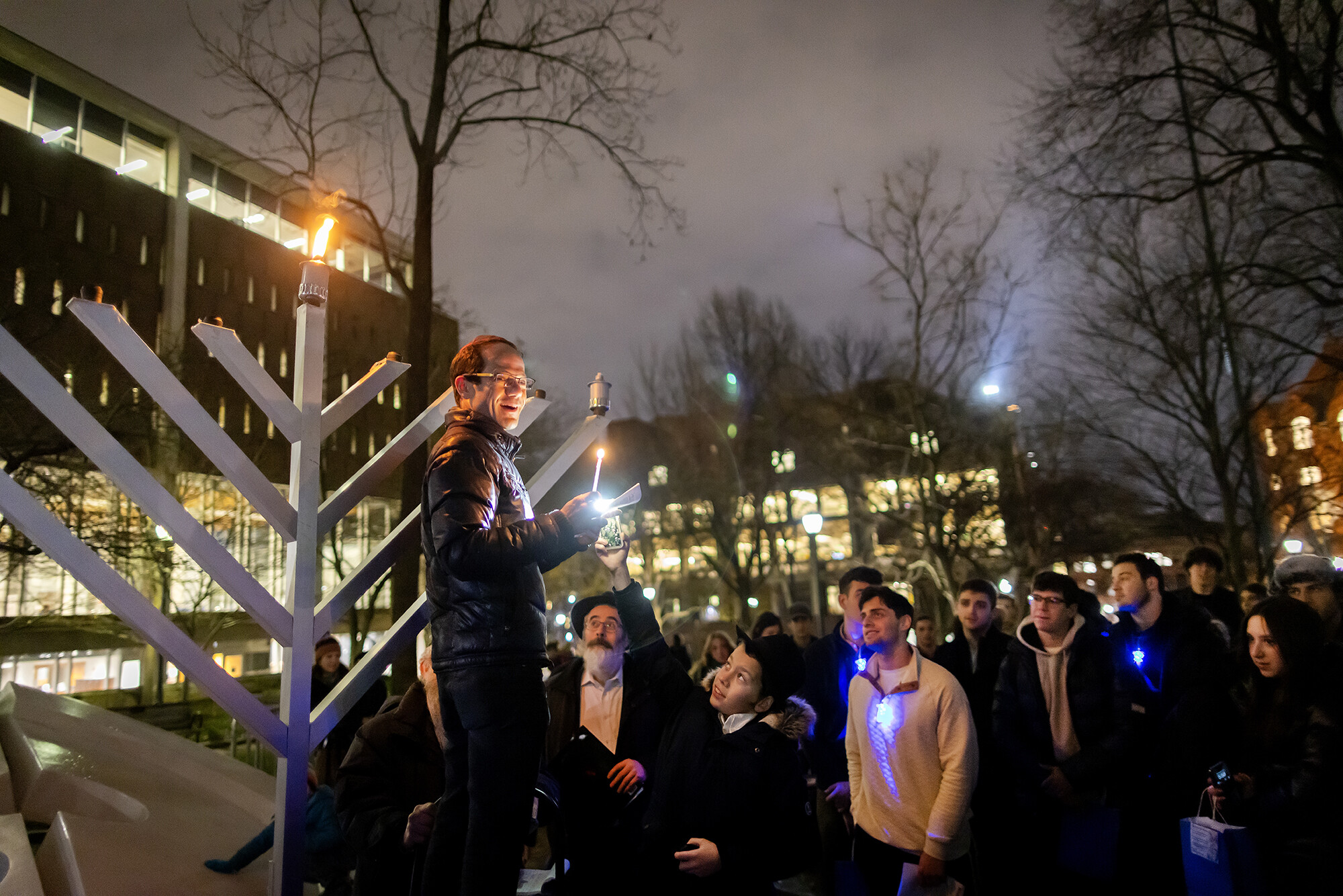 A crowd outside Van Pelt Library and a large menorah to celebrate the start of Hanukkah.