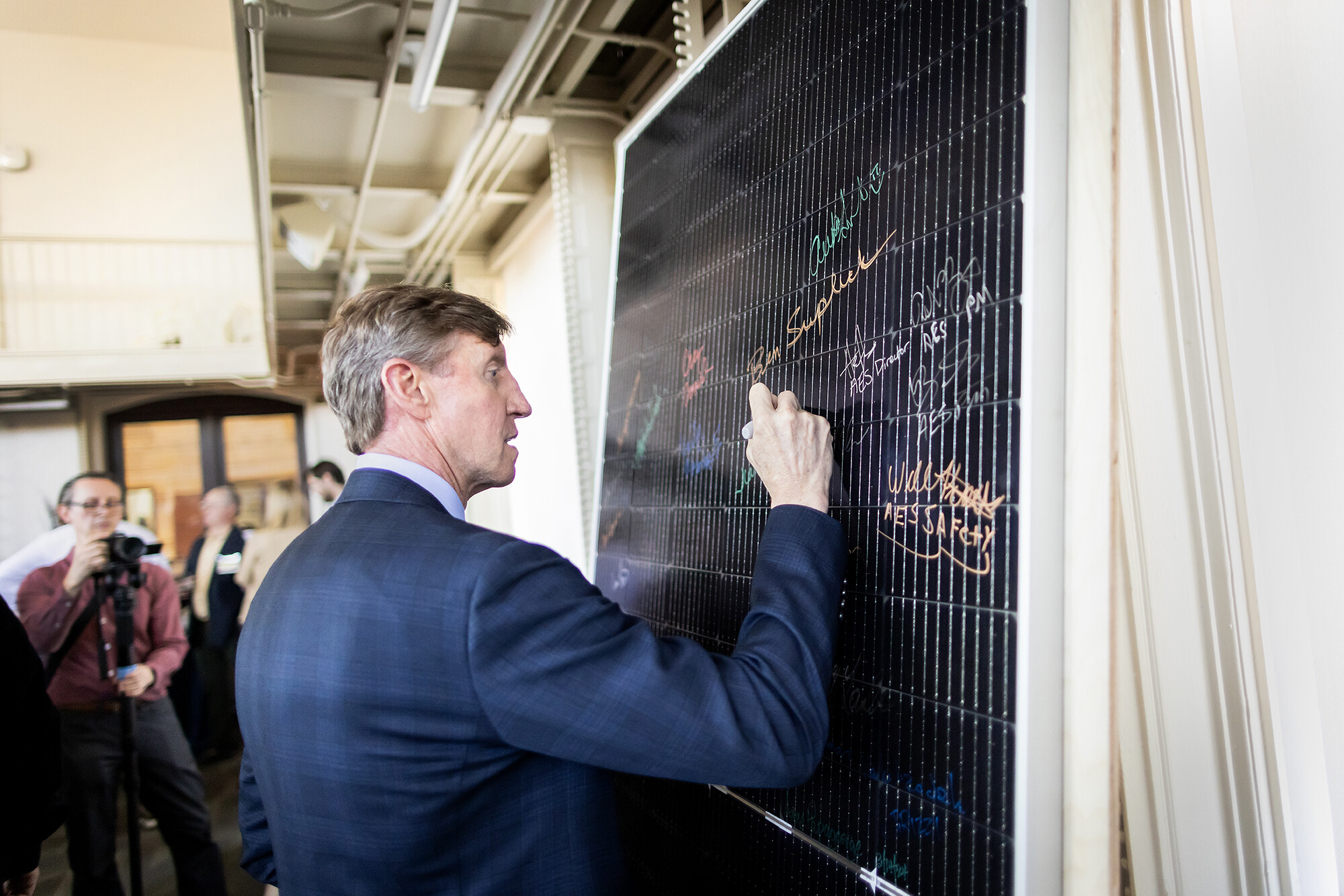 interim president jameson signing a solar panel
