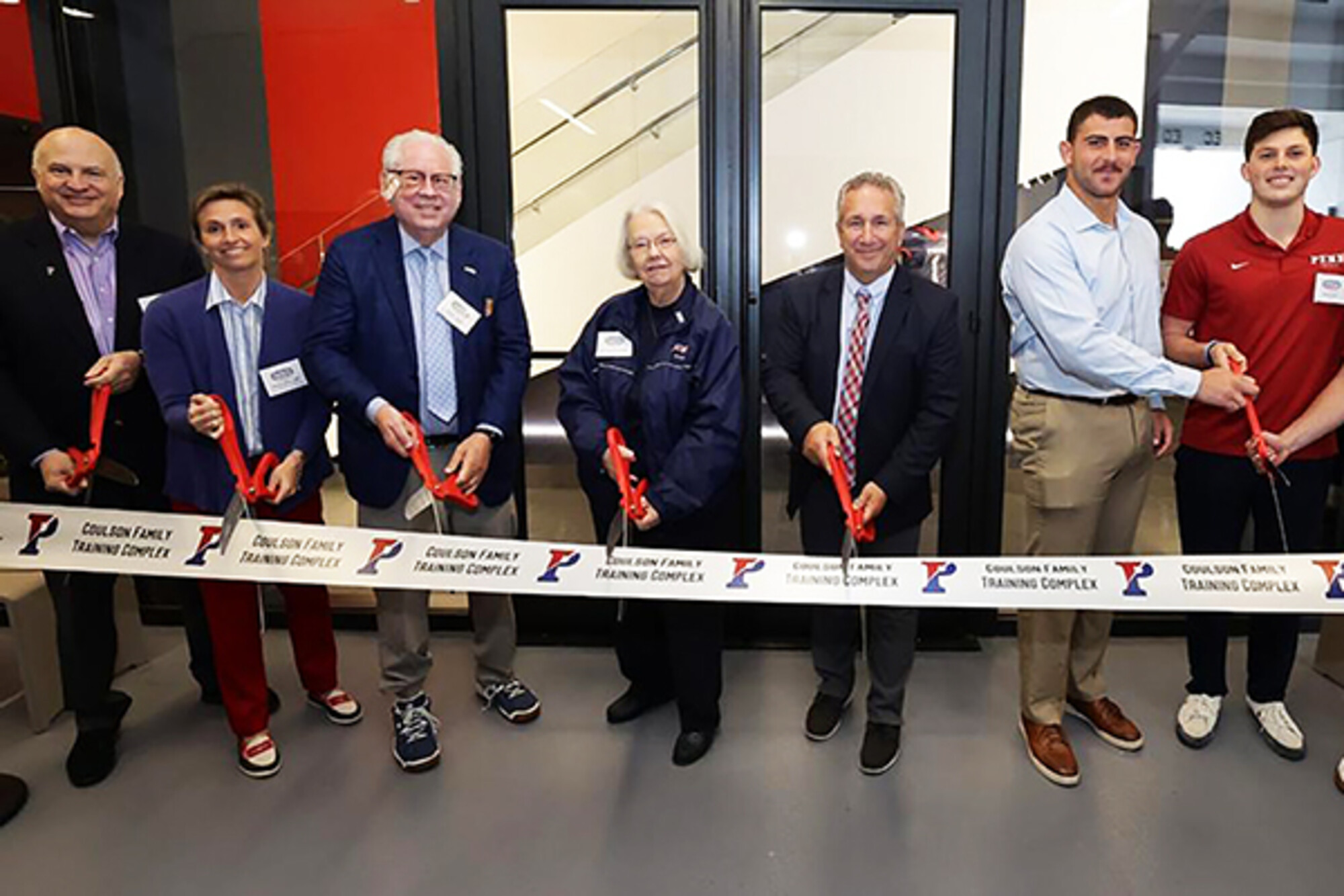 Penn Athletics coaches and administrators cut the ribbon for the Coulson Family Training Complex in Franklin Field.