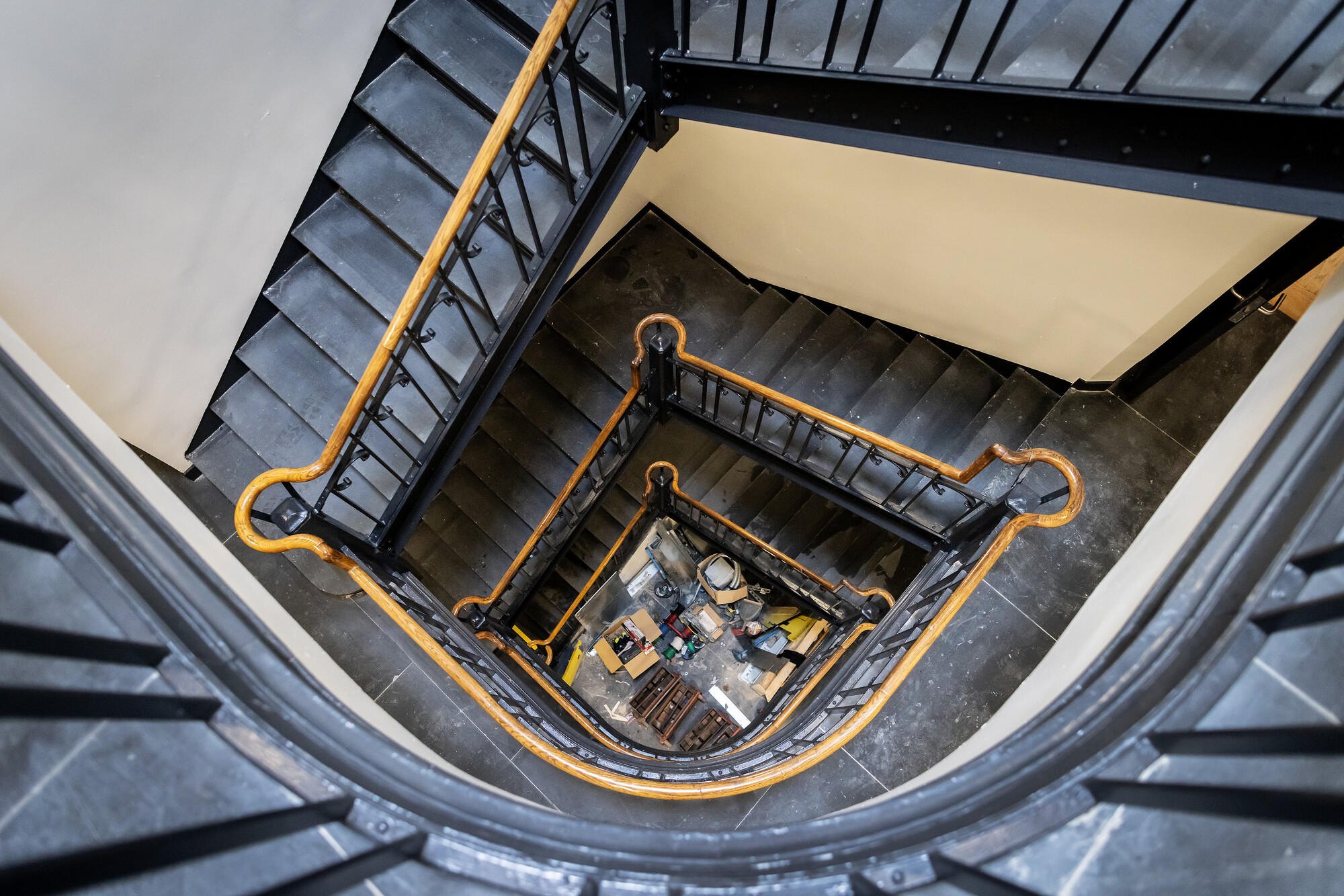 Several flights of stairs with wood railing. 