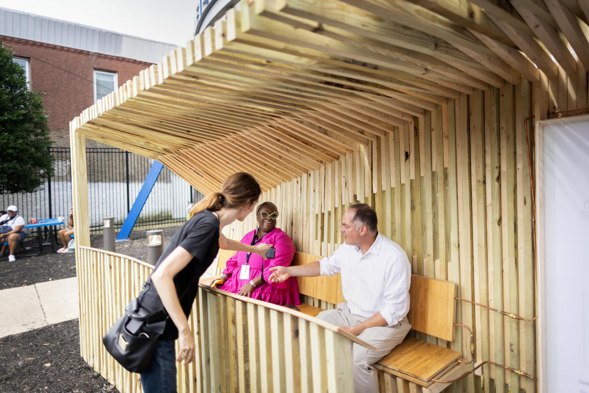 Dorit Aviv, Nikki Bagby and a third person in a cooling shelter prototype in a Philly neighborhood.