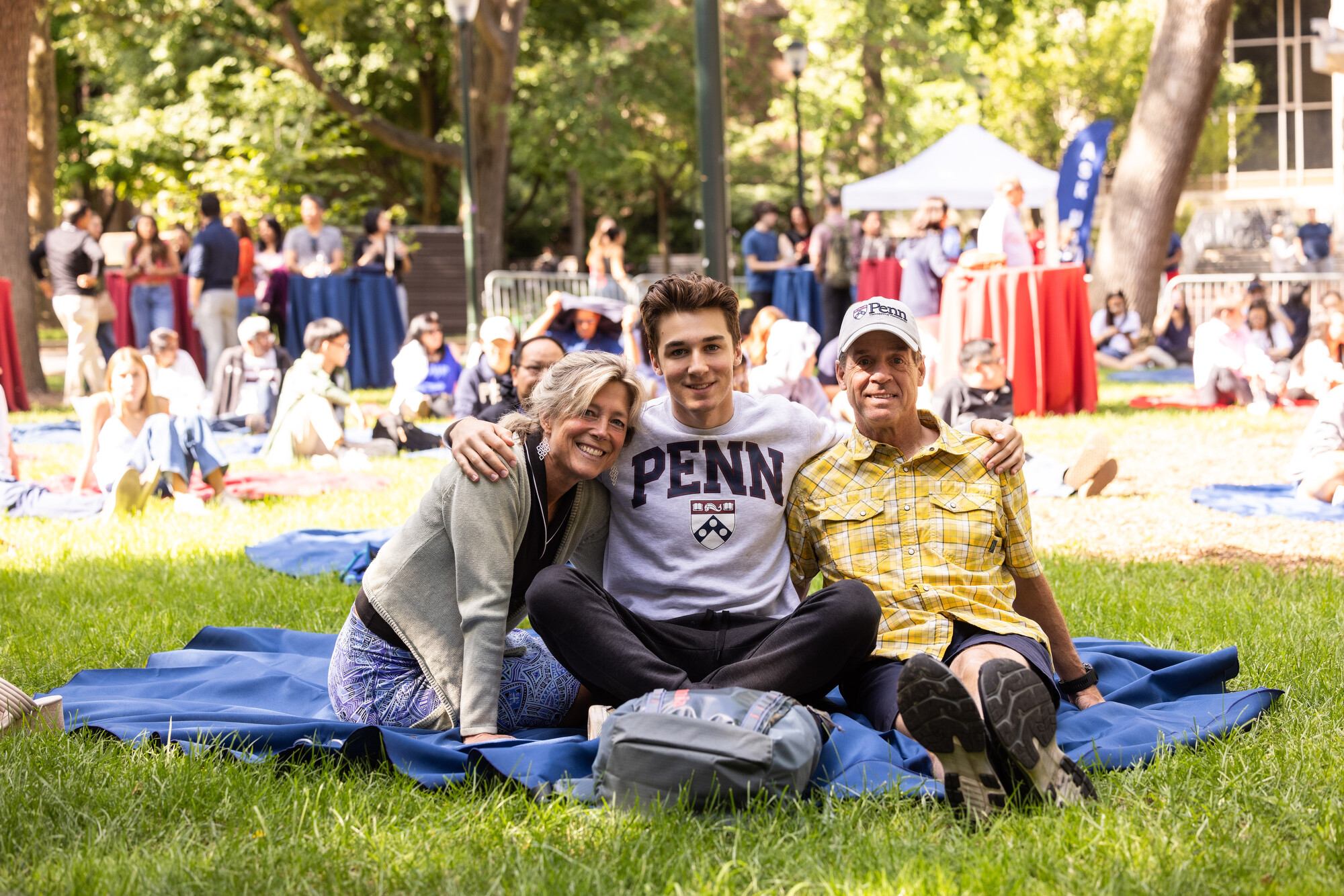 family sitting on college green