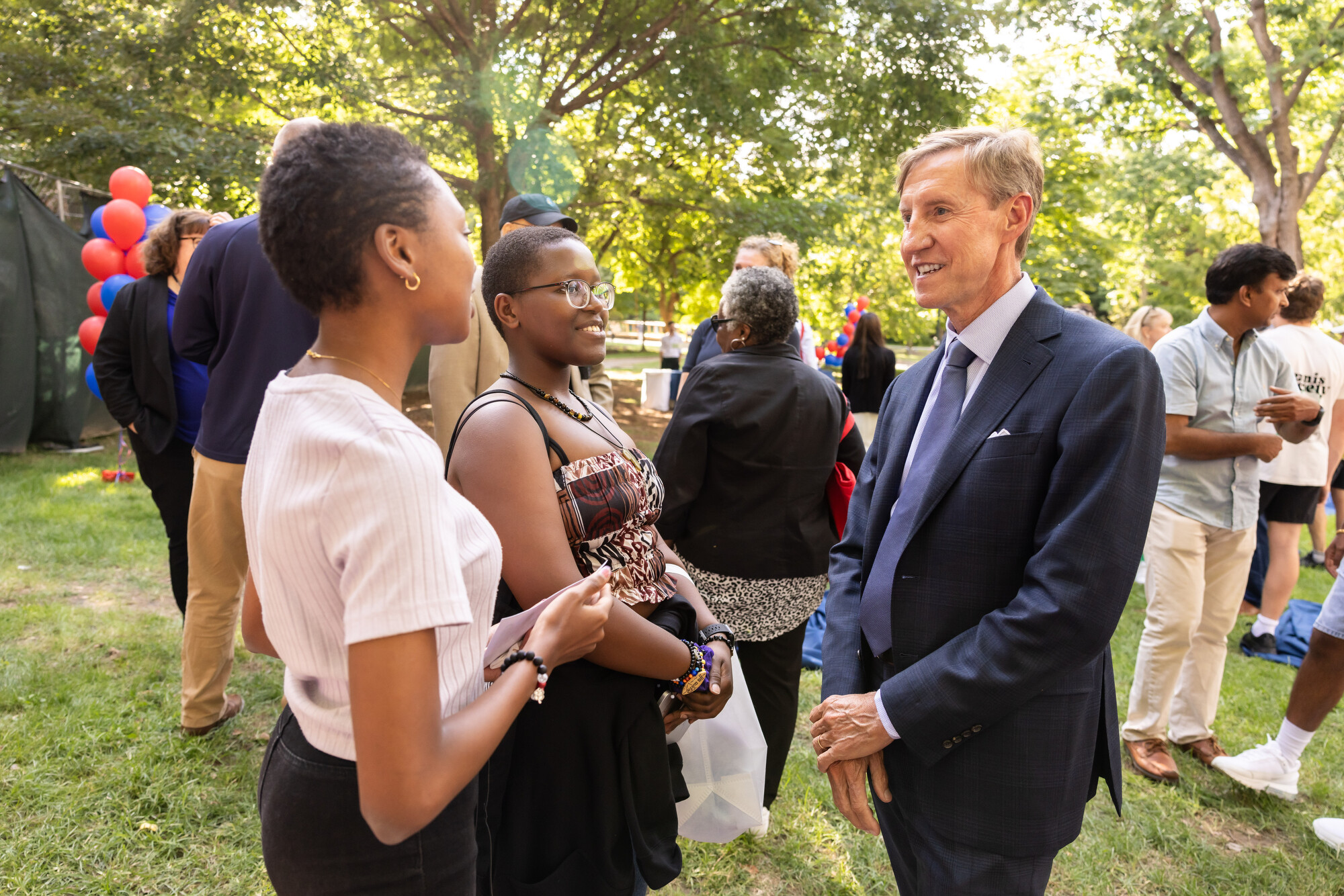 president jameson speaks to a new student at the welcome picnic