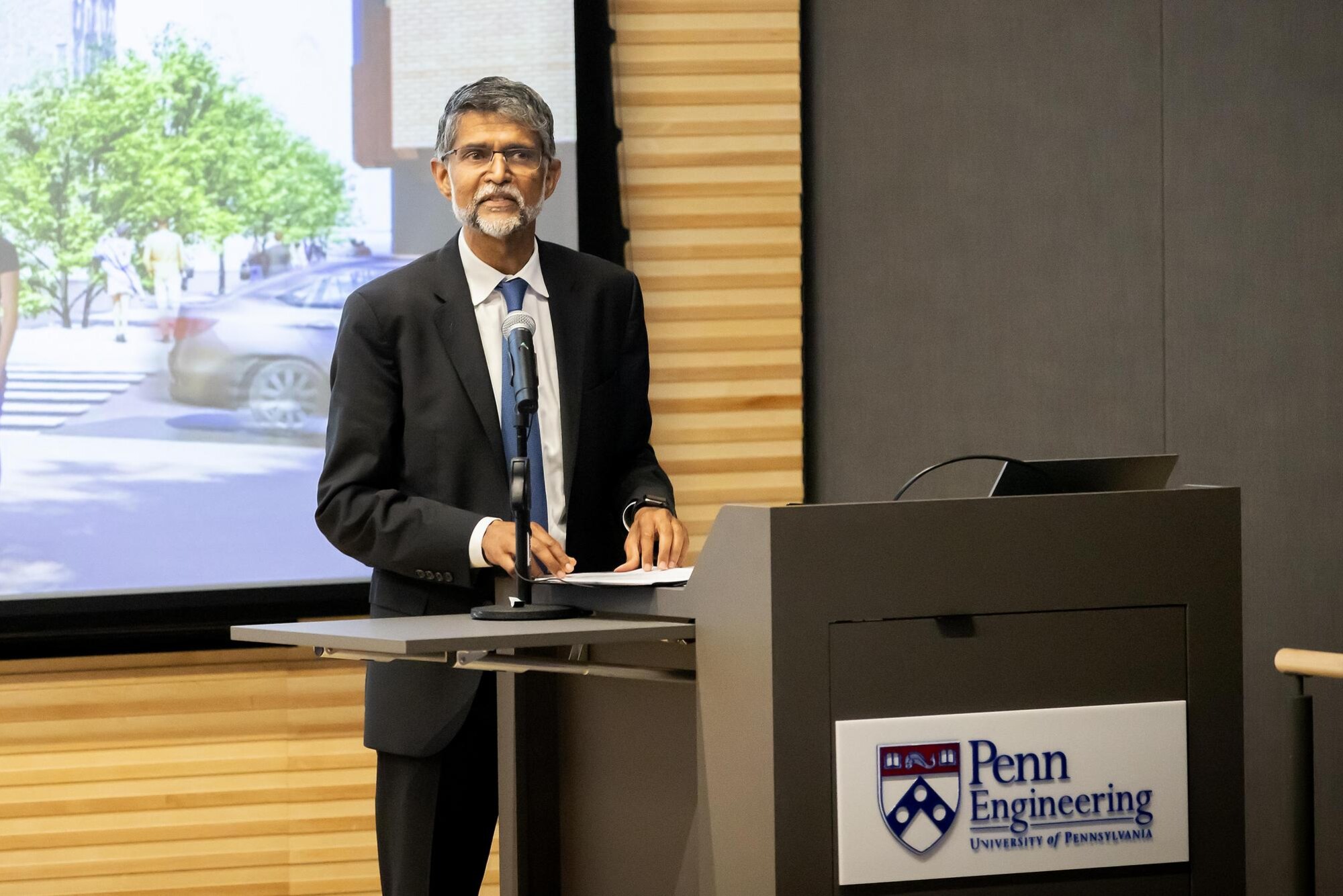 Vijay Kumar at a podium at the ribbon cutting for the Amy Gutmann Hall.