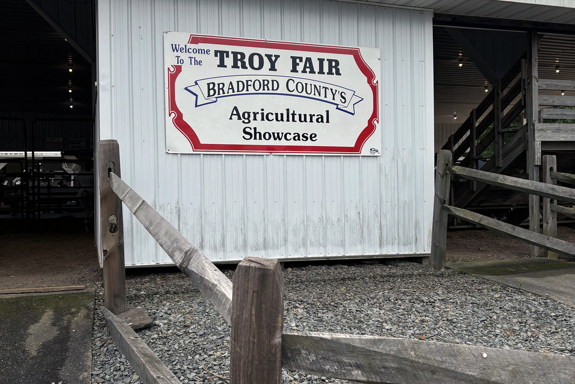 A sign at on a barn door at the Troy County Fair that reads “Troy Fair Bradford County’s Agricultural Showcase”