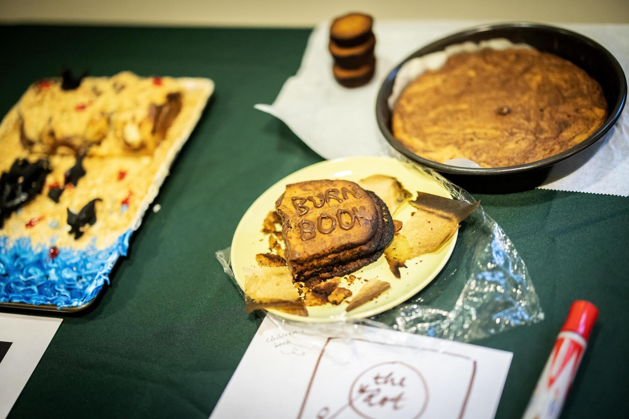 Foodstuffs including a sandwich with the words Burn Book printed on it on a table.