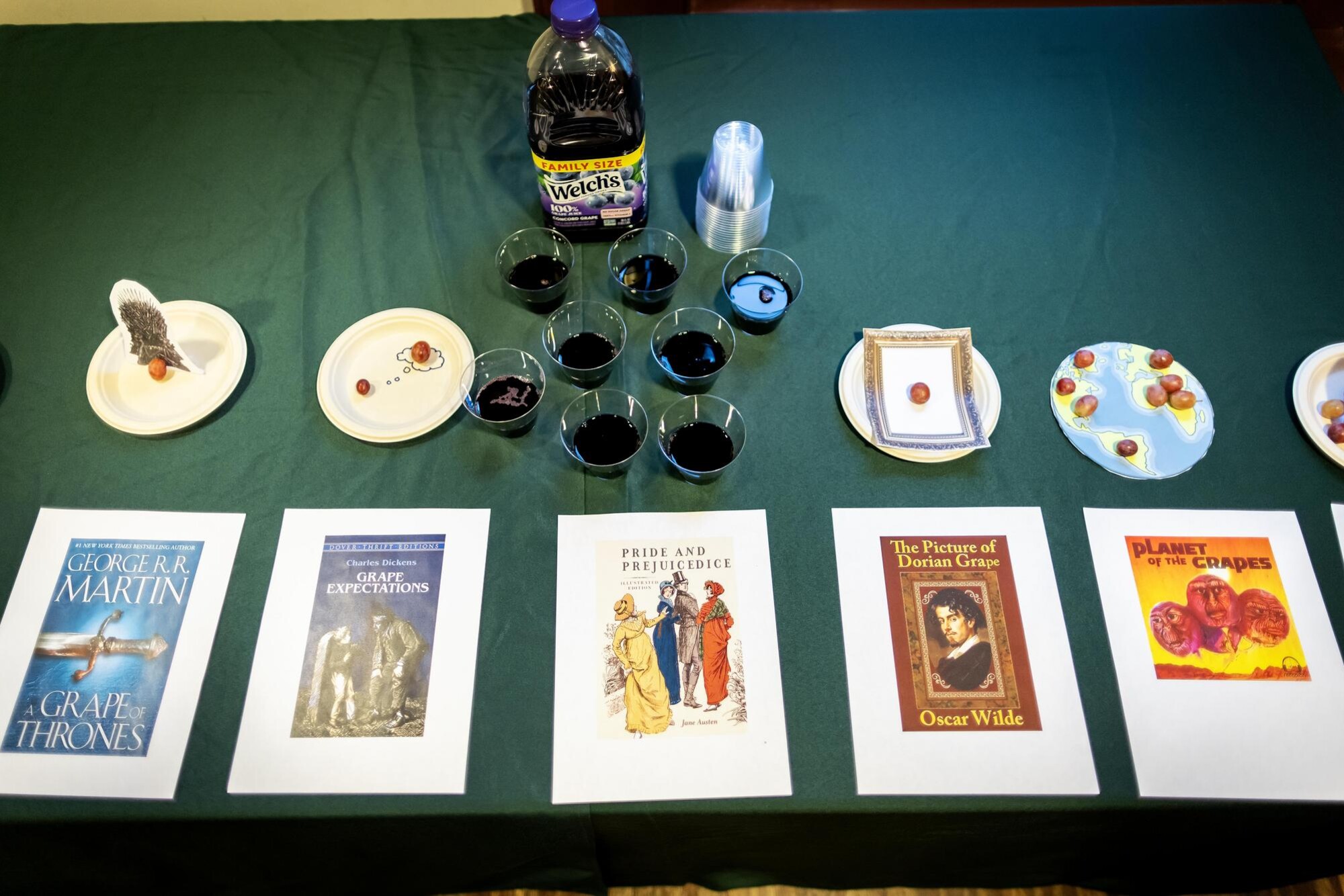 A selection of book covers and snacks and drinks on a table.