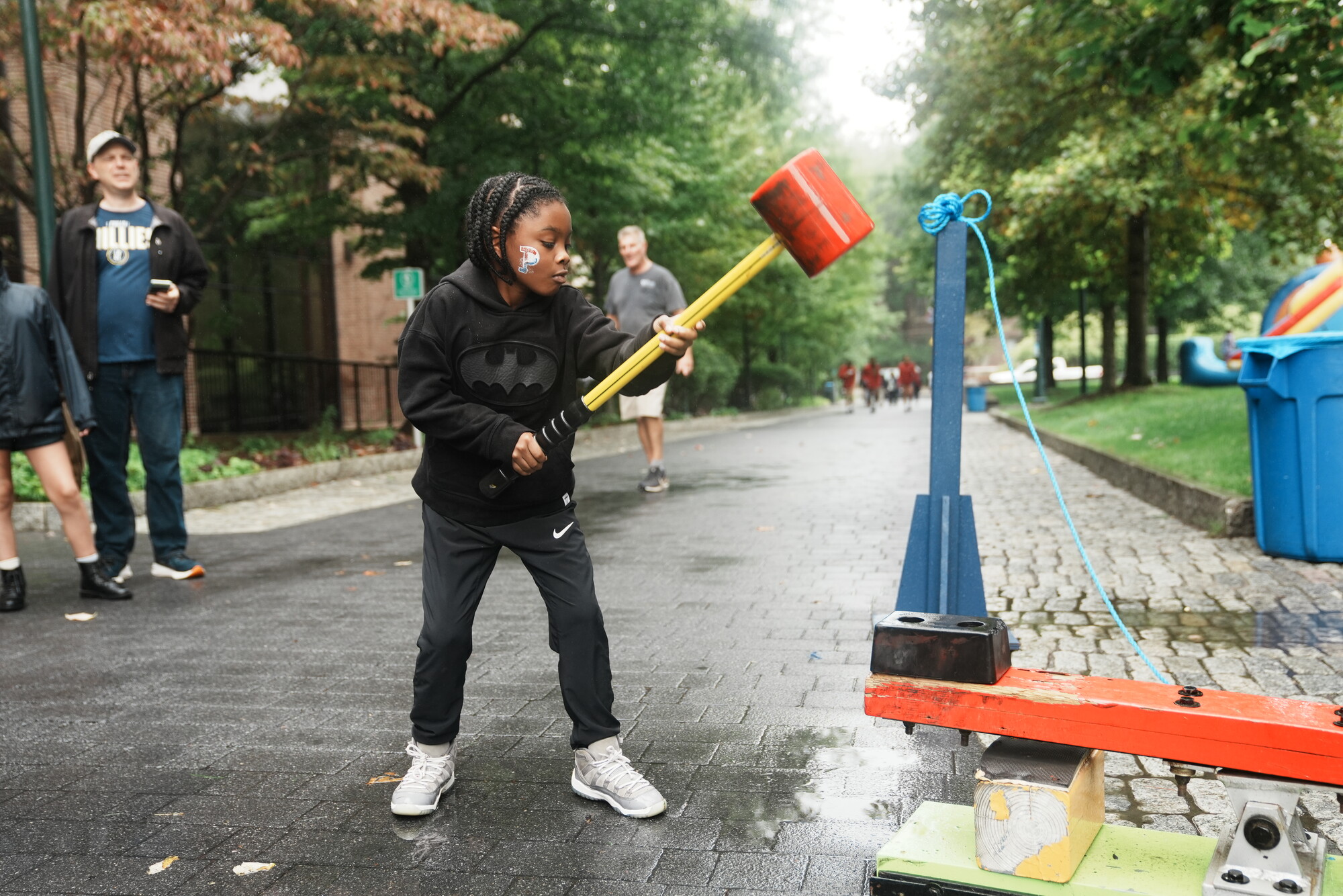 A kid tests a strength machine on Penn’s campus during Friends and Family Weekend.