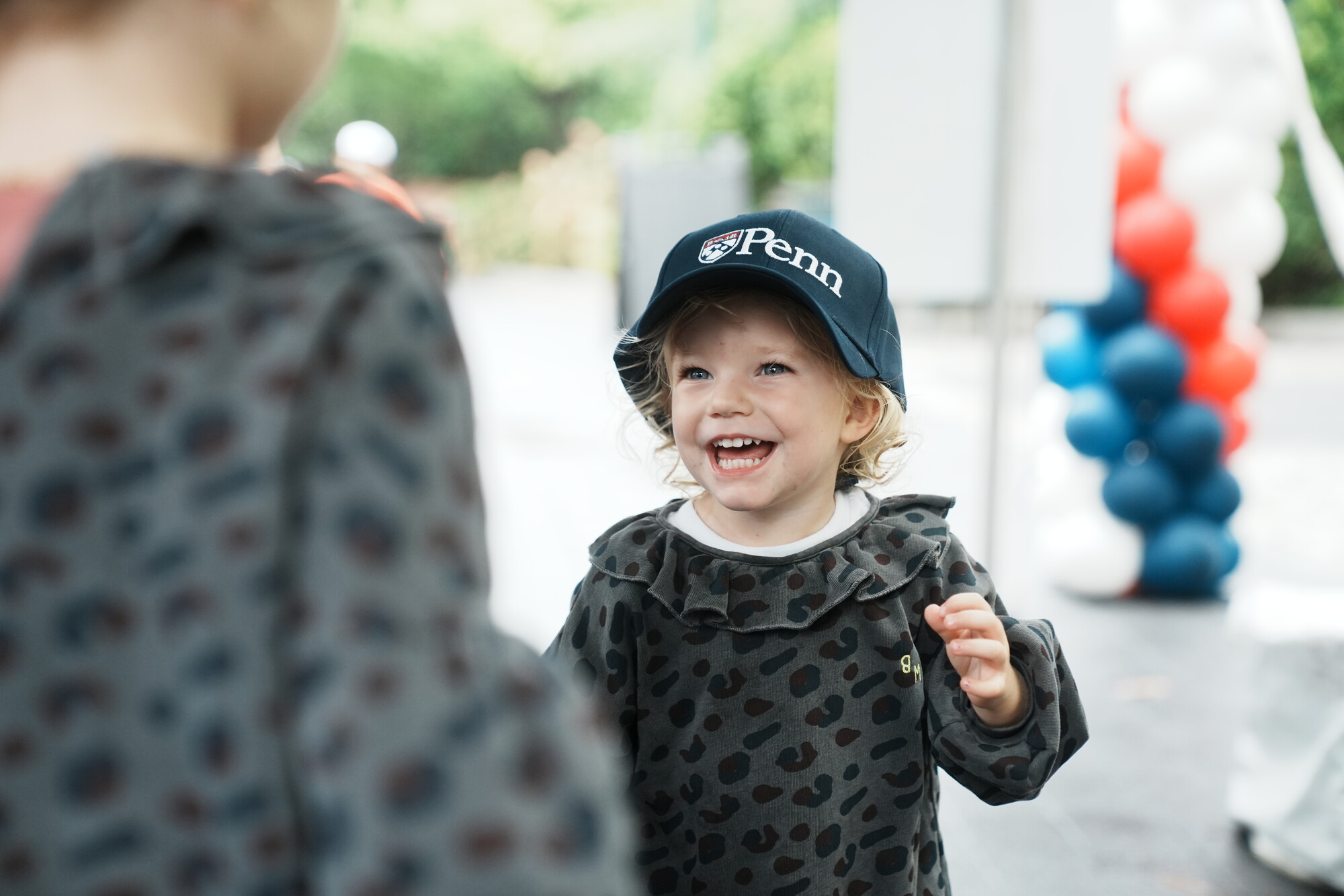 Two small kids on Penn’s campus during Friends and Family Weekend.