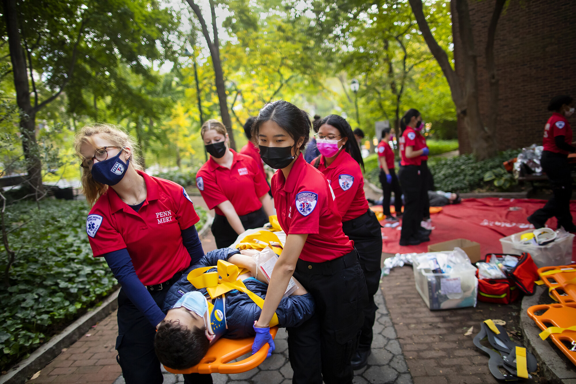 Members of MERT carry a patient on a stretcher.