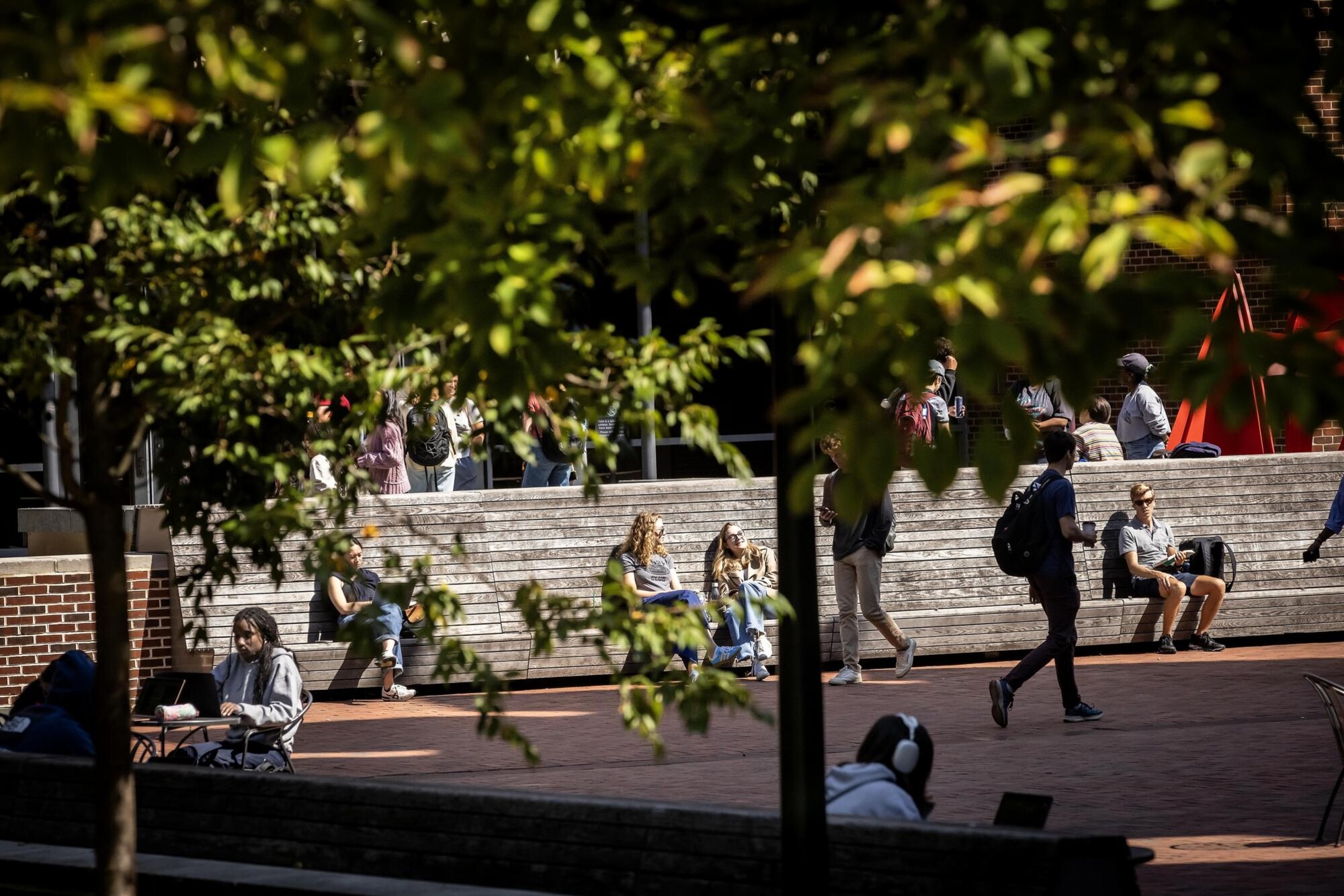 Students sitting outside Penn’s campus in the fall.