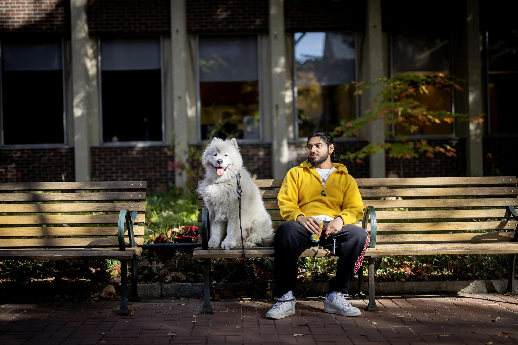 A person and their dog outside of Van Pelt Library.