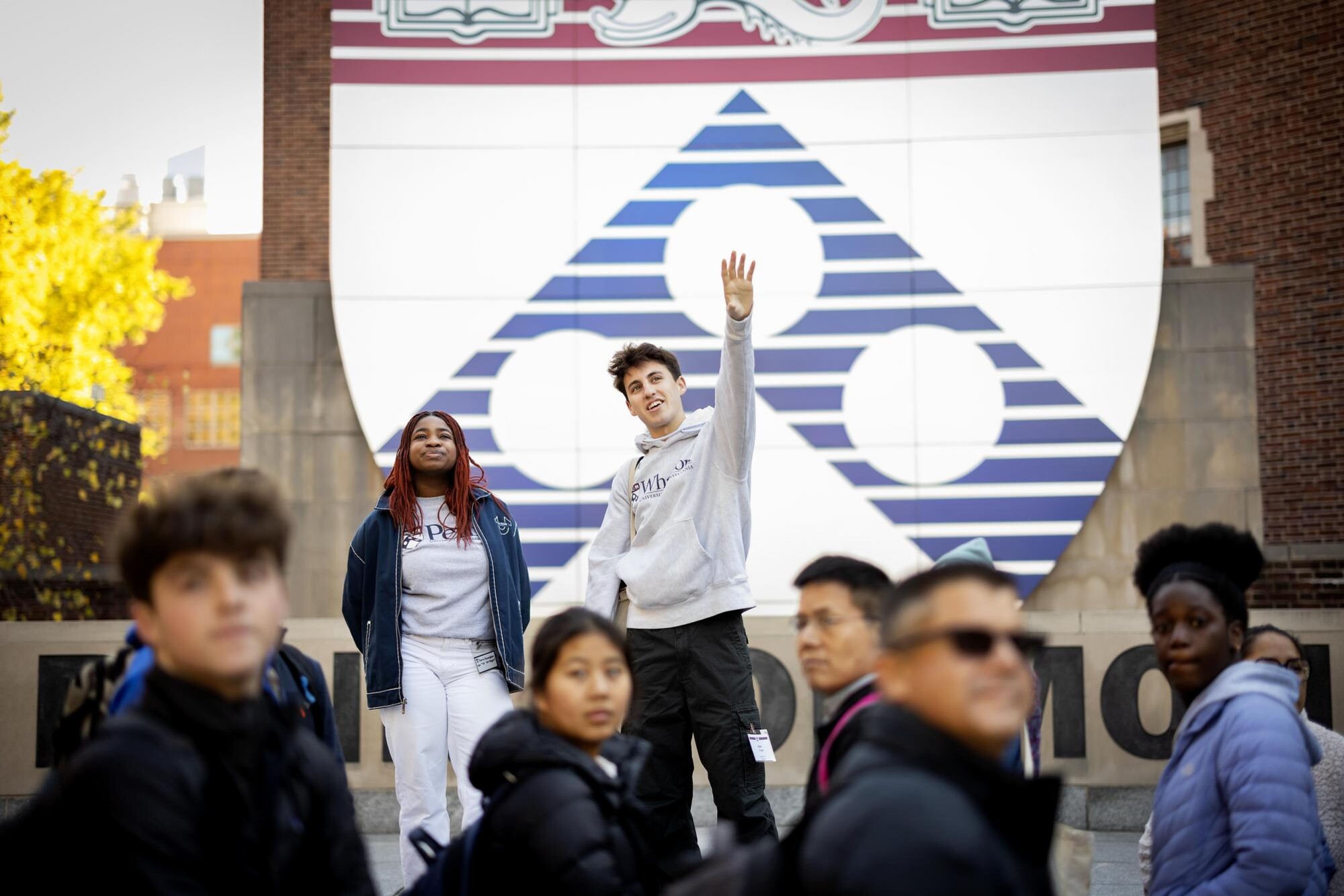 Two members of Kite and Key address a group of people at Penn Commons.