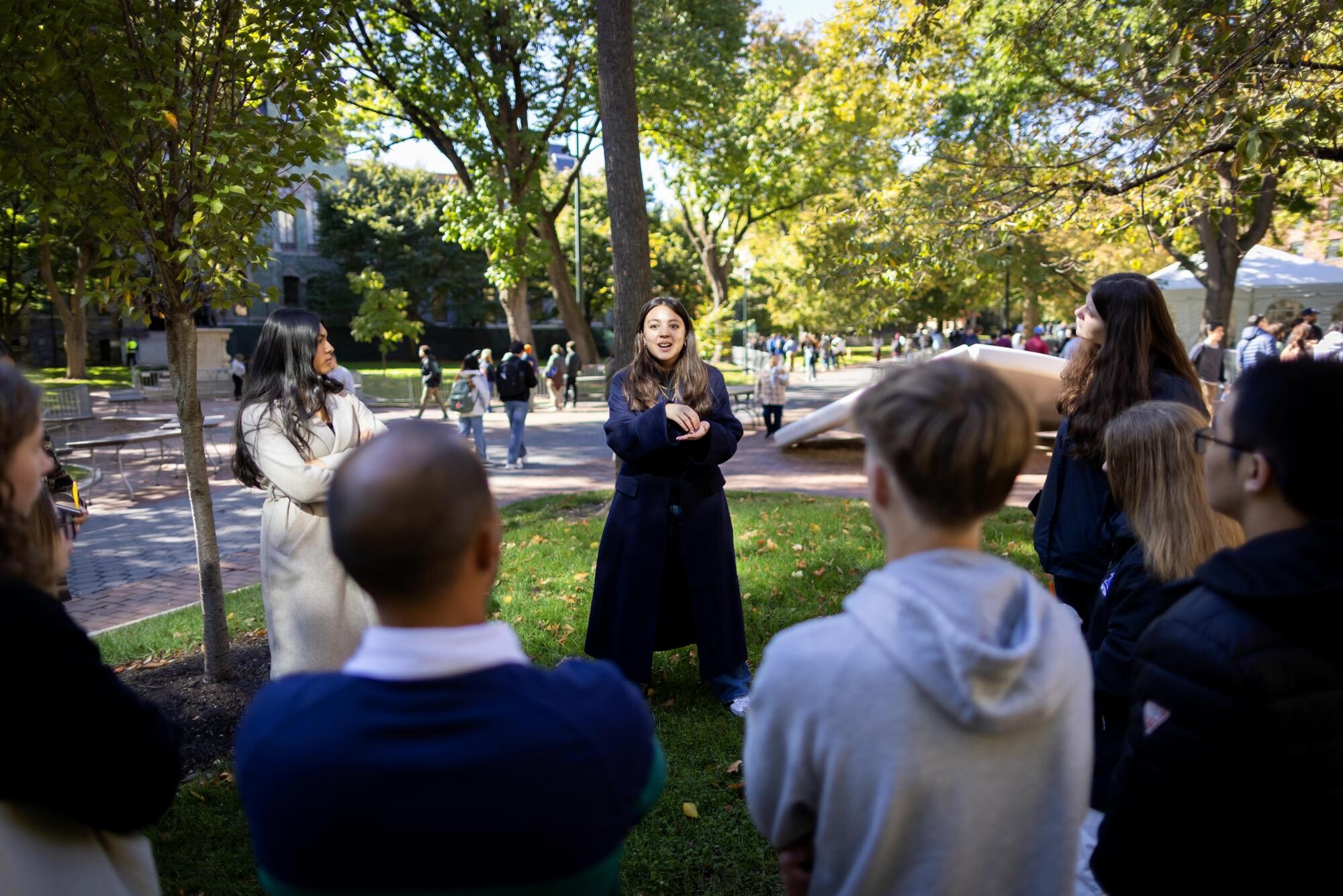 A student addresses a crowd outside on Locust Walk.