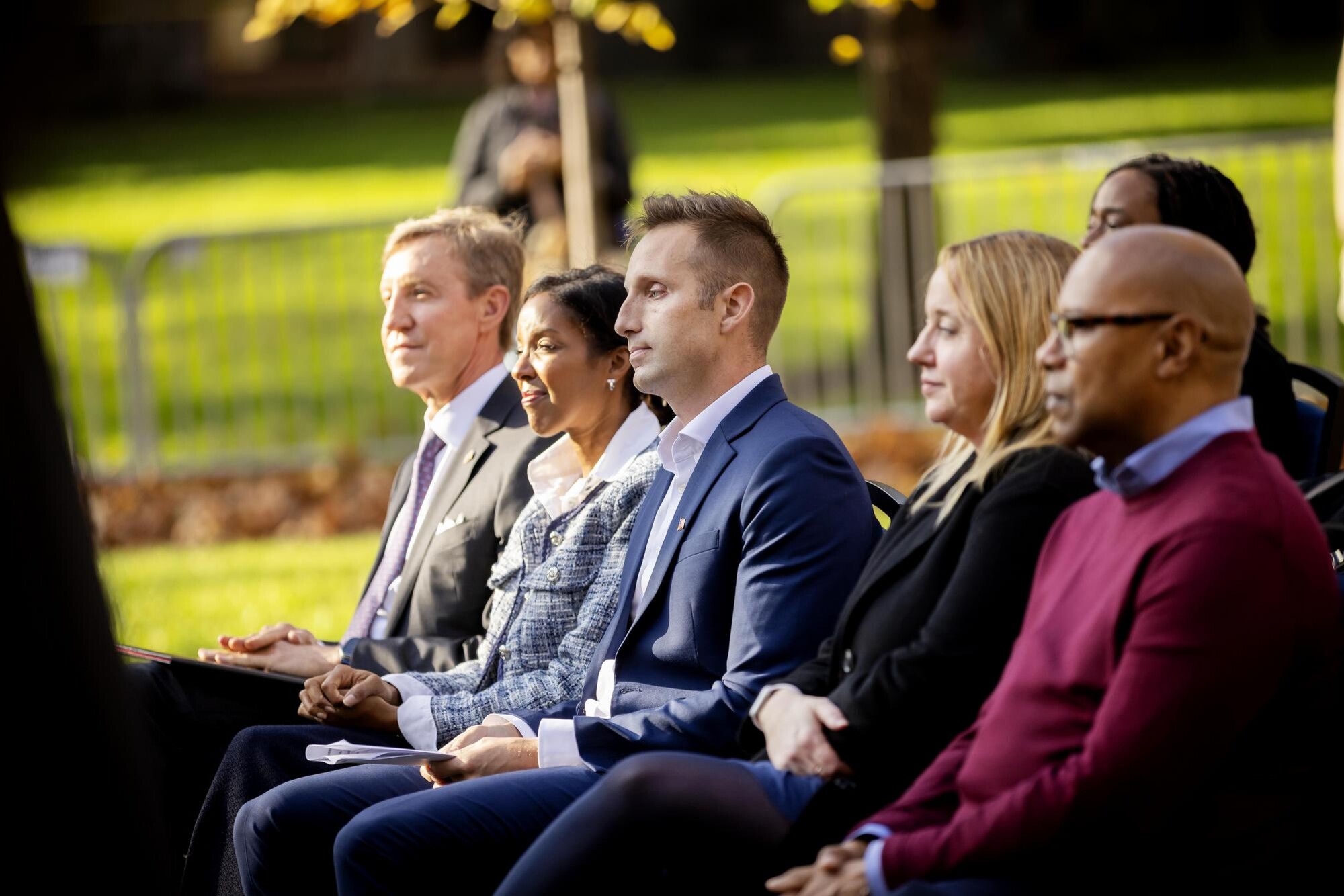 Penn’s Interim President J. Larry Jameson seated with four other people at the Veteran’s Day flag raising ceremony.