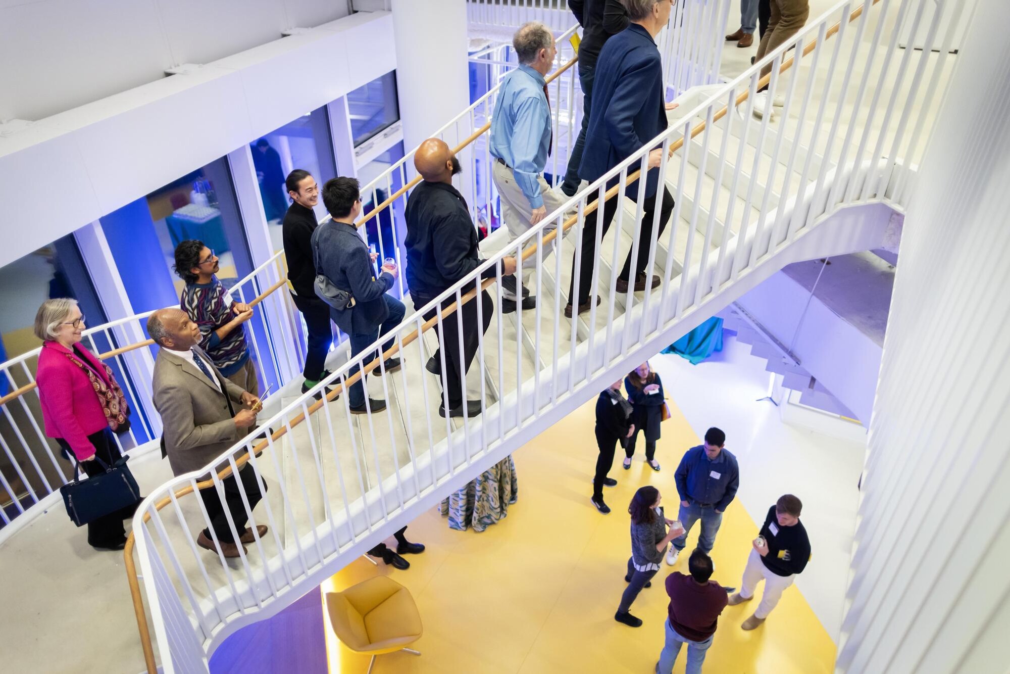 People walking up a staircase in the new Vagelos building.