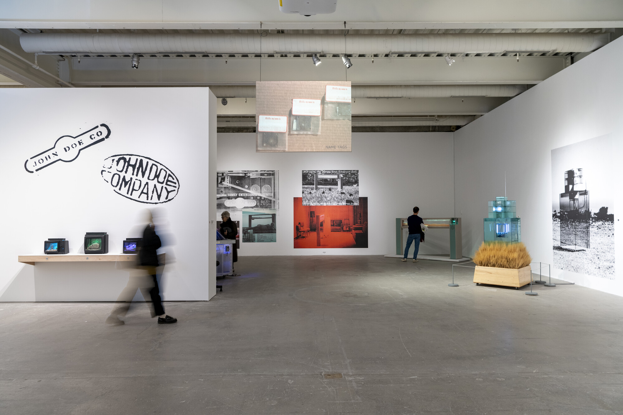 View of ICA gallery with John Doe Company on wall with several sculptures displayed
