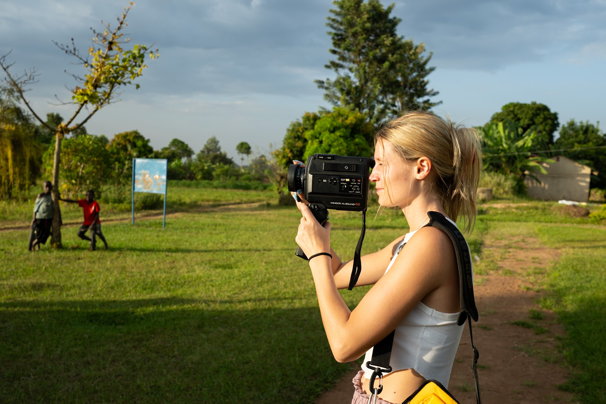 Student filming with video camera outside