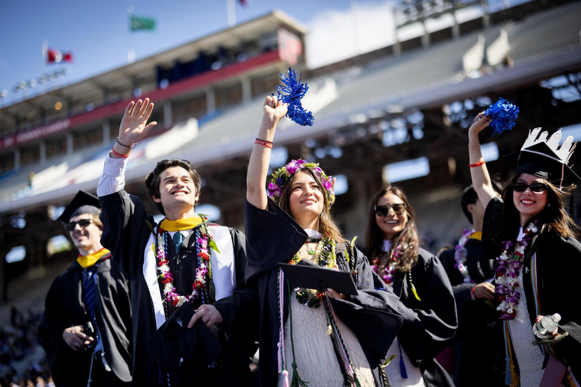 Students waving at Franklin Field during Penn’s Commencement.
