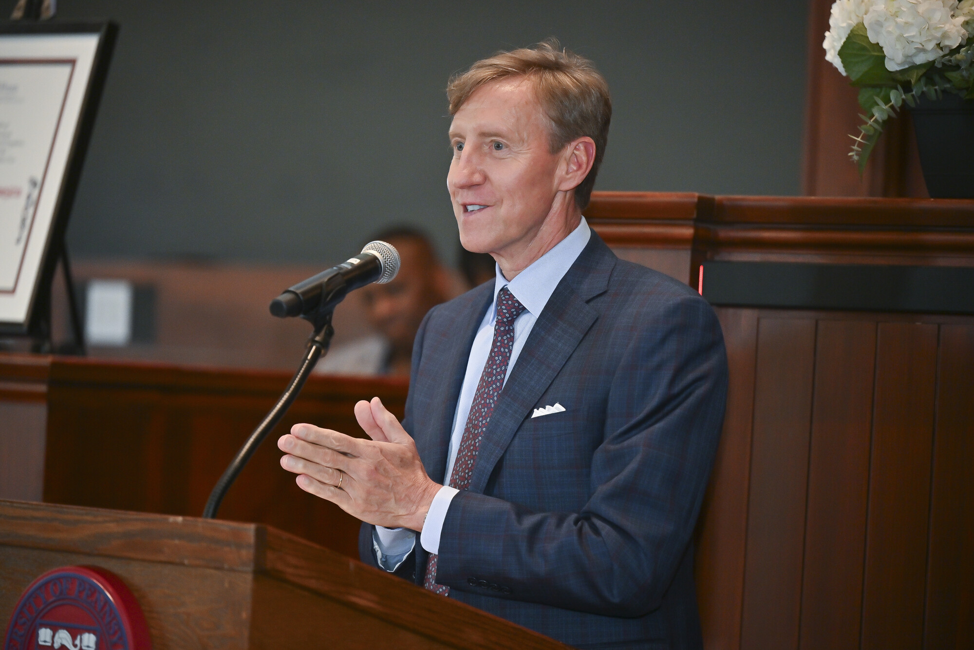 Penn President J. Larry Jameson speaking at a podium at the Ivy Day ceremony.
